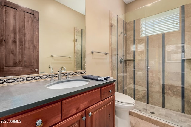 full bathroom with vanity, toilet, and tiled shower