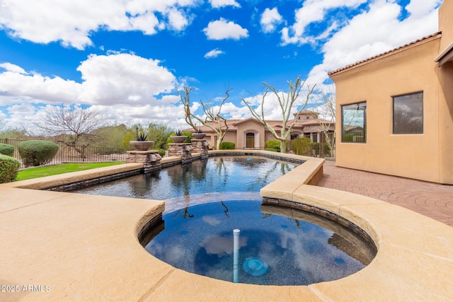 view of pool featuring a patio area, an in ground hot tub, and fence