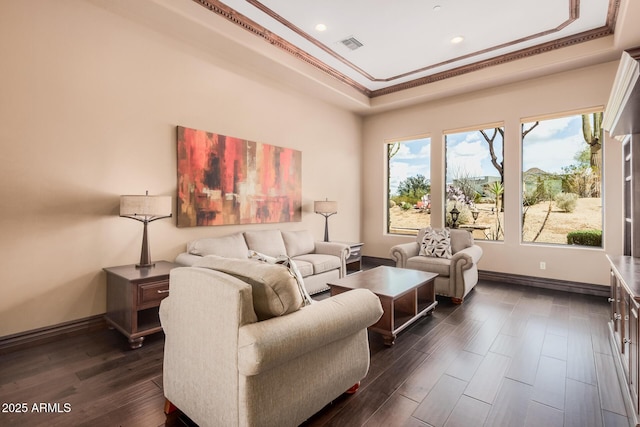 living area with visible vents, dark wood-type flooring, a tray ceiling, crown molding, and baseboards