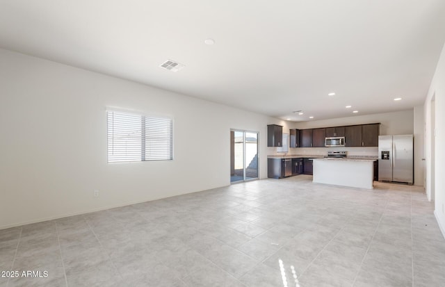 4993 S 254th Dr, Buckeye, AZ 85326 - unfurnished living room with recessed lighting and light tile patterned flooring