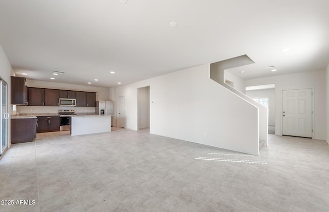 4993 S 254th Dr, Buckeye, AZ 85326 - unfurnished living room with recessed lighting and a sink