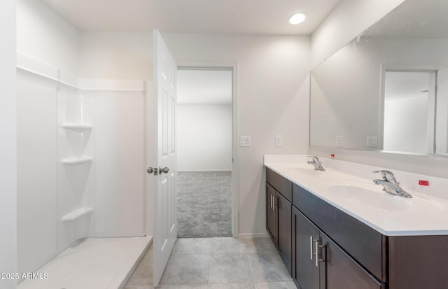4993 S 254th Dr, Buckeye, AZ 85326 - bathroom featuring double vanity, baseboards, tile patterned flooring, recessed lighting, and a shower