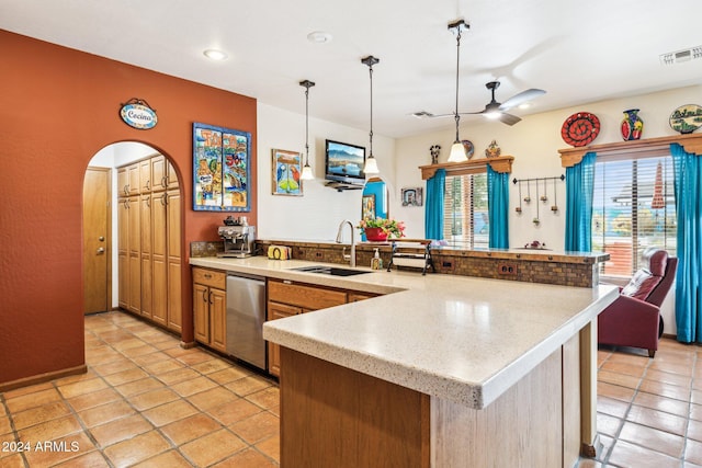 kitchen featuring pendant lighting, dishwasher, sink, ceiling fan, and light tile patterned floors