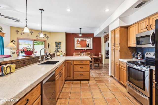 kitchen featuring sink, stainless steel appliances, kitchen peninsula, pendant lighting, and light tile patterned floors