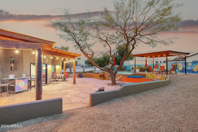 playground at dusk featuring a patio