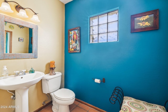 bathroom with sink, tile patterned flooring, and toilet