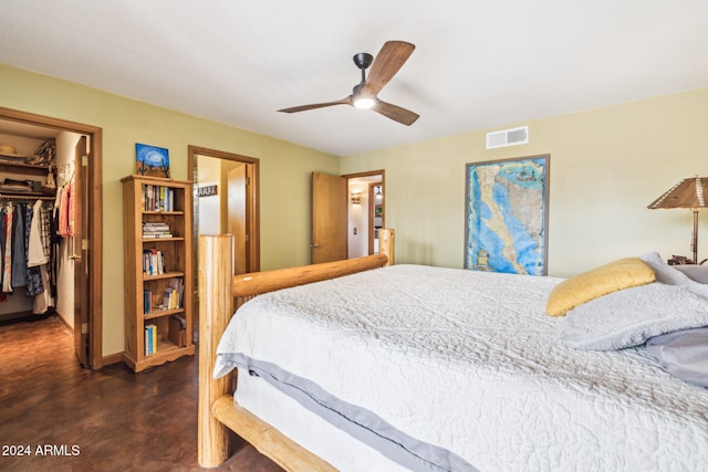 bedroom featuring ceiling fan, a walk in closet, and a closet