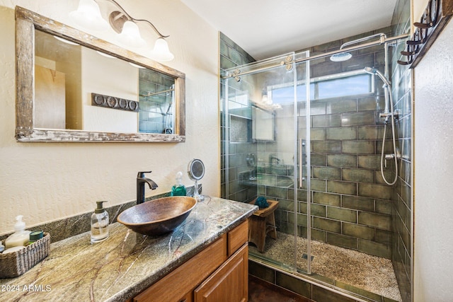 bathroom featuring vanity and an enclosed shower