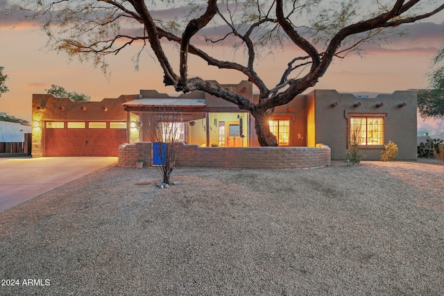 adobe home featuring a garage