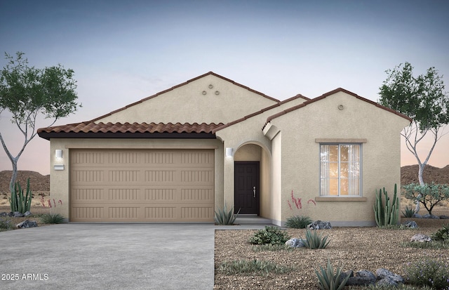 mediterranean / spanish house featuring driveway, an attached garage, and stucco siding