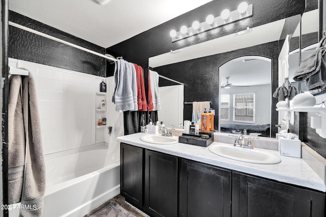 bathroom with ceiling fan, vanity, and shower / tub combo