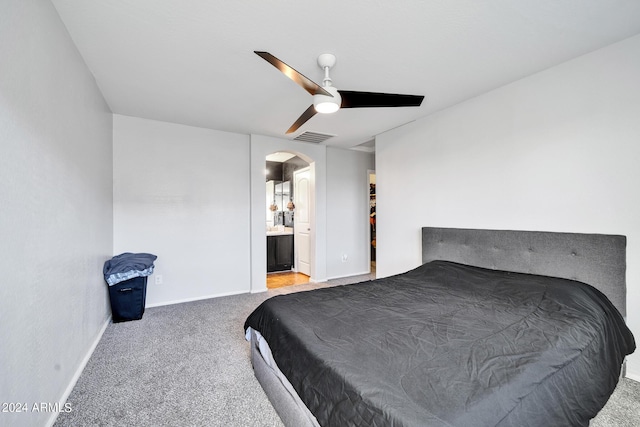 bedroom featuring carpet flooring, ceiling fan, and ensuite bath