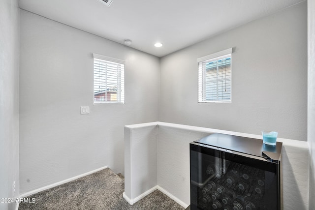 laundry room with carpet and wine cooler