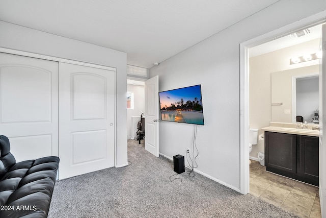 carpeted living room with sink