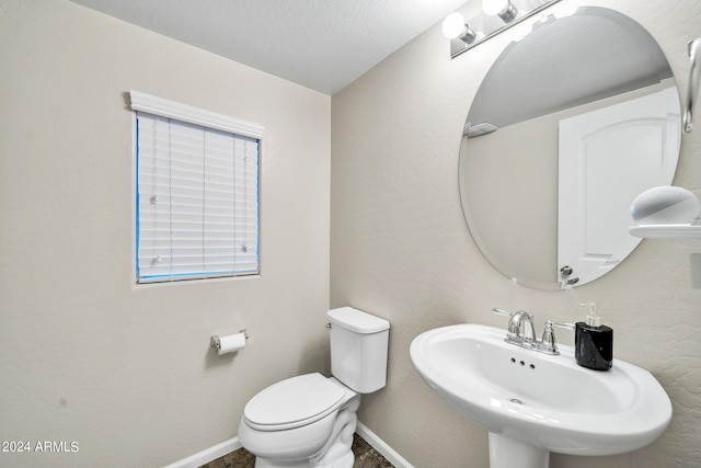 bathroom featuring toilet and sink