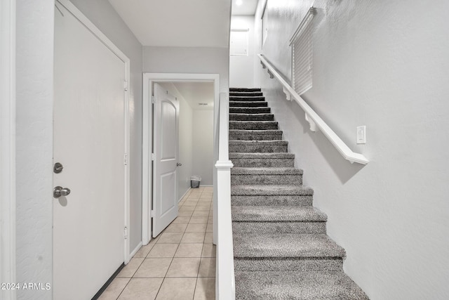 stairway featuring tile patterned floors