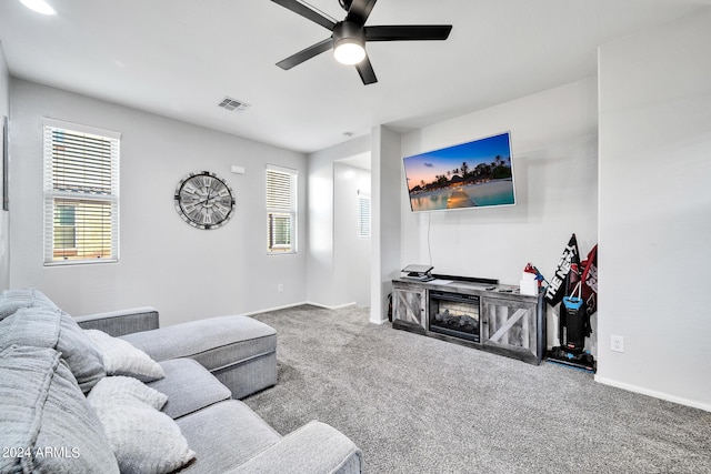 carpeted living room with ceiling fan