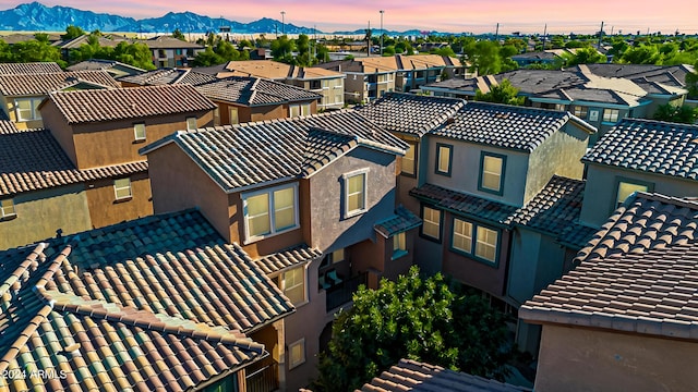 aerial view at dusk featuring a mountain view