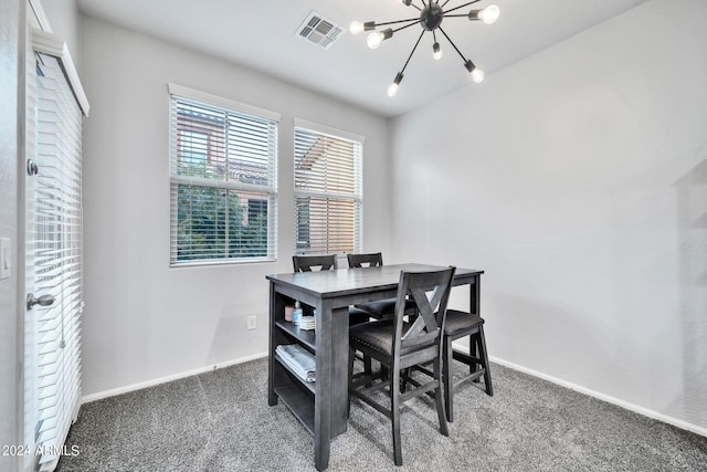 carpeted dining room with a chandelier