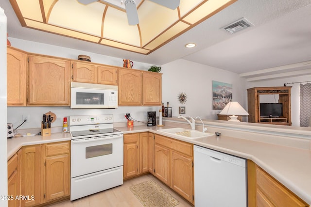 kitchen with light countertops, white appliances, a sink, and visible vents