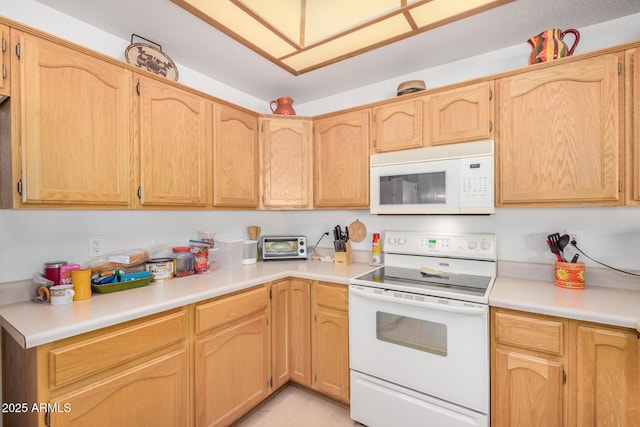 kitchen featuring white appliances and light countertops