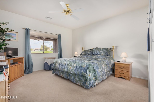 bedroom with light carpet, ceiling fan, visible vents, and baseboards