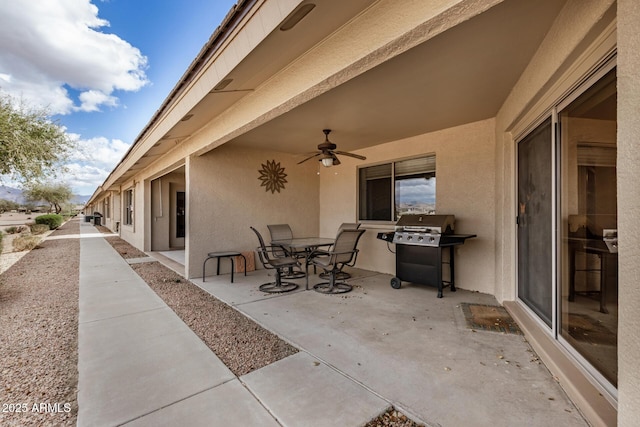 view of patio featuring outdoor dining area, a grill, and a ceiling fan