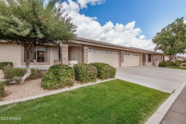 view of front of house featuring an attached garage, a front yard, concrete driveway, and stucco siding