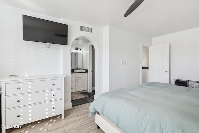 bedroom with ceiling fan and ensuite bath