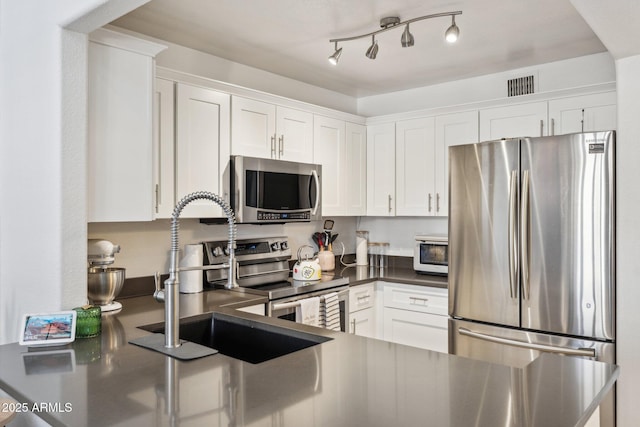 kitchen featuring white cabinetry, appliances with stainless steel finishes, and sink