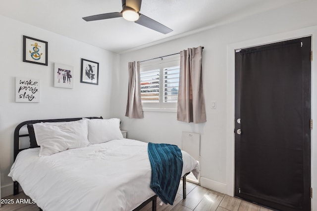 bedroom with ceiling fan and light hardwood / wood-style floors