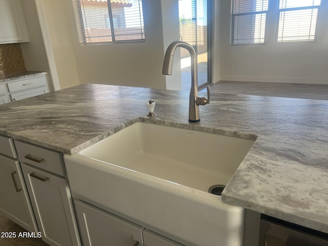 details with light stone countertops and sink