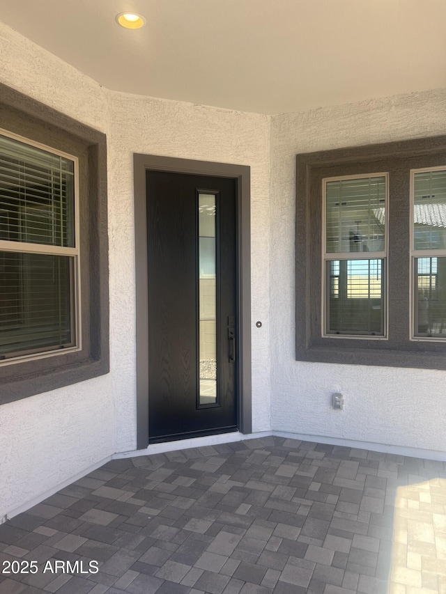 property entrance featuring a patio area