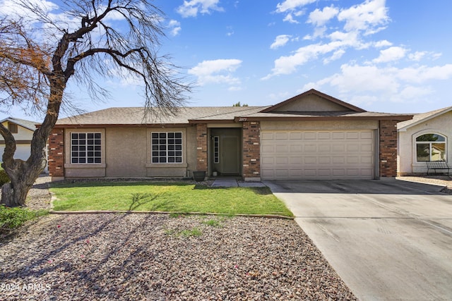 ranch-style house featuring a front yard and a garage