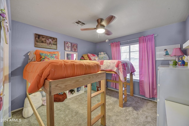 carpeted bedroom featuring ceiling fan and washer / dryer