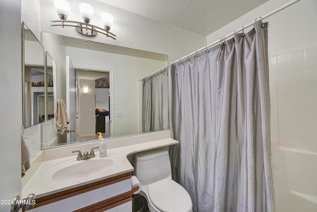 full bathroom featuring vanity, shower / bath combo, and toilet