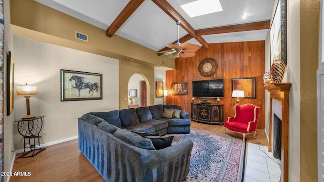 426 E Carol Ann Way, Phoenix, AZ 85022 - living area with wood walls, beam ceiling, arched walkways, high vaulted ceiling, and a ceiling fan