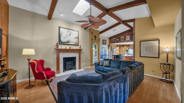 426 E Carol Ann Way, Phoenix, AZ 85022 - living room featuring a fireplace with flush hearth, hardwood / wood-style flooring, a skylight, and ceiling fan