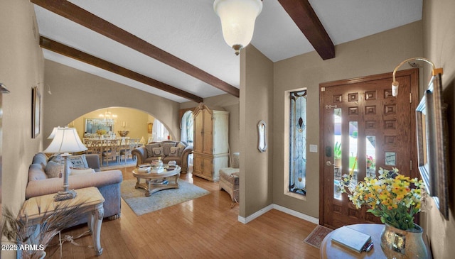 426 E Carol Ann Way, Phoenix, AZ 85022 - living area featuring arched walkways, light wood finished floors, and a chandelier