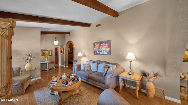 426 E Carol Ann Way, Phoenix, AZ 85022 - living area featuring arched walkways, wood finished floors, and beamed ceiling