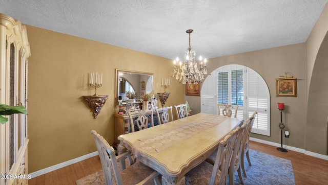 426 E Carol Ann Way, Phoenix, AZ 85022 - dining room with a chandelier, wood finished floors, and a textured ceiling
