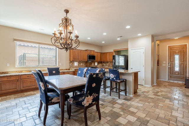 7169 S Dodane Ct, Gilbert, AZ 85298 - dining room with a chandelier, recessed lighting, baseboards, and stone tile floors