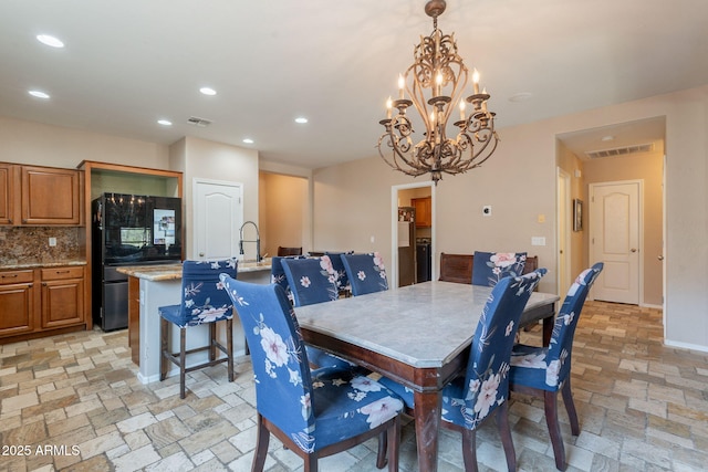 7169 S Dodane Ct, Gilbert, AZ 85298 - dining space with recessed lighting, a chandelier, stone tile flooring, and baseboards