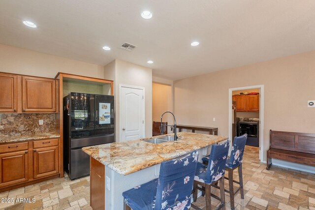 7169 S Dodane Ct, Gilbert, AZ 85298 - kitchen featuring freestanding refrigerator, a sink, light stone countertops, stone tile floors, and recessed lighting