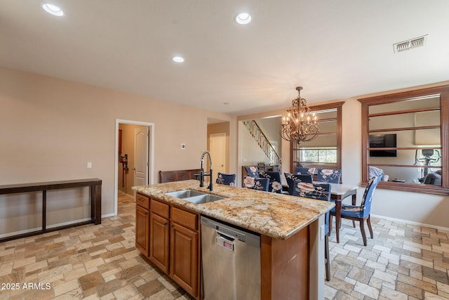 7169 S Dodane Ct, Gilbert, AZ 85298 - kitchen with stainless steel dishwasher, a sink, brown cabinetry, recessed lighting, and an island with sink