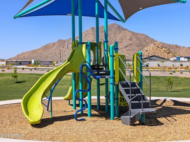 view of jungle gym with a mountain view and a lawn