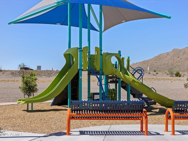 view of playground with a mountain view