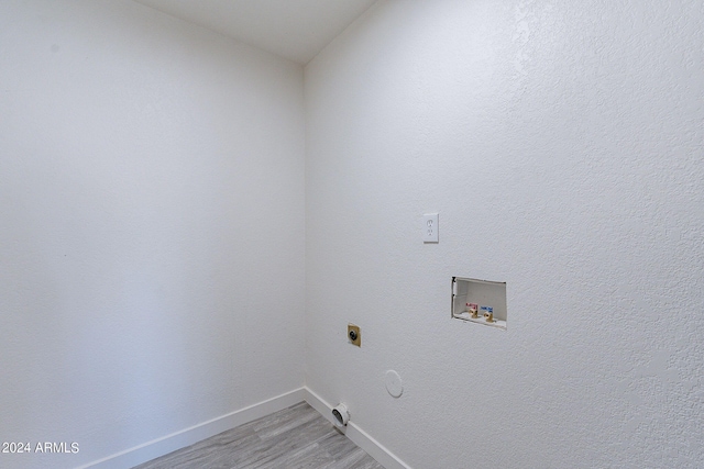 laundry room with hookup for a washing machine, hardwood / wood-style floors, hookup for a gas dryer, and electric dryer hookup