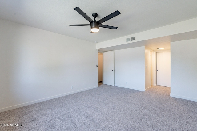 unfurnished bedroom with light colored carpet and ceiling fan