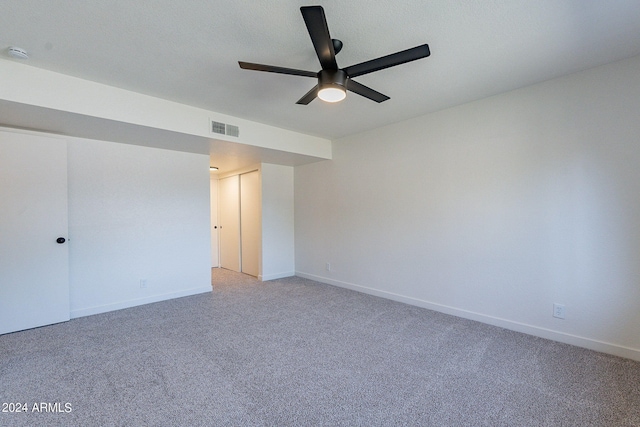 carpeted empty room featuring a textured ceiling and ceiling fan